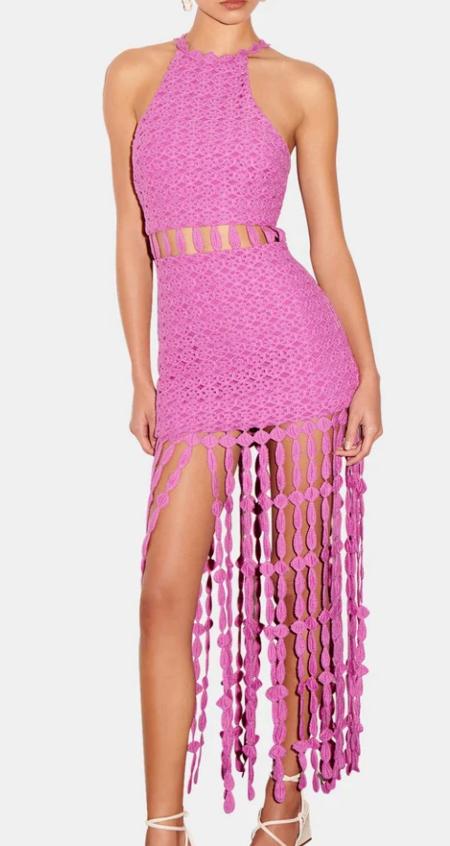 A pink knit midi dress with fringe details, displayed on a mannequin.